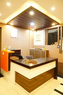 a fast food kitchen with a counter in a restaurant at Rainbow Inn in Munnar