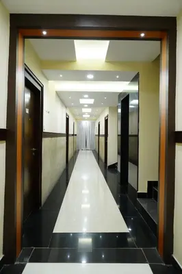 a hallway in a building with a hallway at Rainbow Inn in Munnar