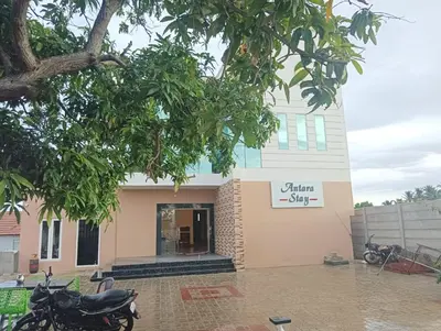 a building with a motorcycle parked in front of it at ANTARA STAY in Coimbatore