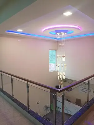 a room with a ceiling with a chandelier at ANTARA STAY in Coimbatore