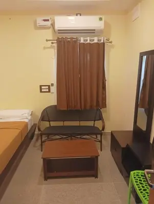 a room with a bed and a air conditioner at ANTARA STAY in Coimbatore