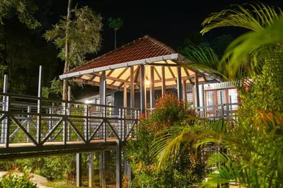 a building with a bridge in front of it at B'camp Resorts & Homestays in Wayanad