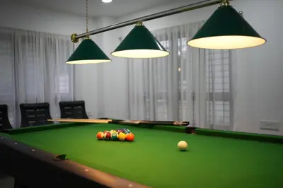 a green pool table with balls on top of it at B'camp Resorts & Homestays in Wayanad