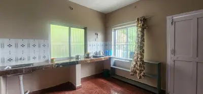 a kitchen with a sink and a window at Heath Cote in Ooty