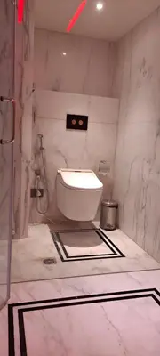 a bathroom with a toilet in the corner of a room at Fortune Park, Tiruppur - Member ITC Hotels' Group in Tiruppūr