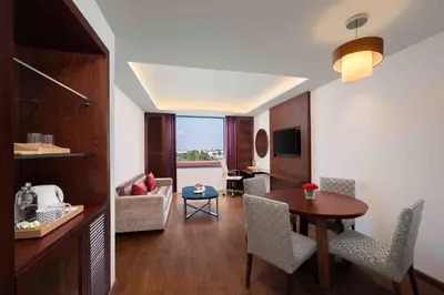 a room with a table and chairs and a living room at Fortune Park, Tiruppur - Member ITC Hotels' Group in Tiruppūr