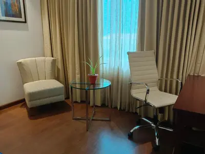 a room with a glass table and two chairs and a window at Fortune Park, Tiruppur - Member ITC Hotels' Group in Tiruppūr