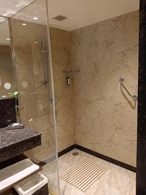 a bathroom with a shower with a glass door at Fortune Park, Tiruppur - Member ITC Hotels' Group in Tiruppūr