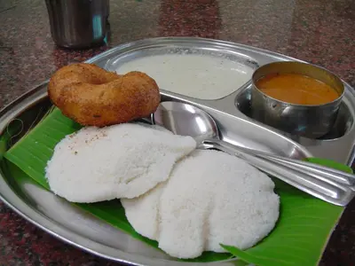 a plate of food with rice and a bowl of soup at La Flora kodaikanal in Kodaikānāl