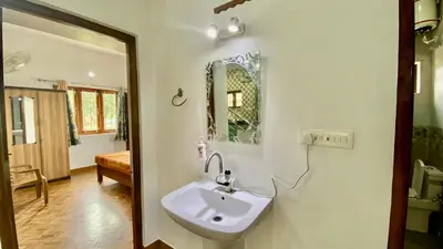 a bathroom with a sink and a mirror on the wall at La Flora kodaikanal in Kodaikānāl