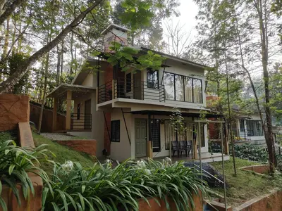 a small house in the middle of a forest at Safari Hills in Vayittiri