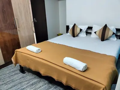 a hotel room with a bed with two towels on it at 