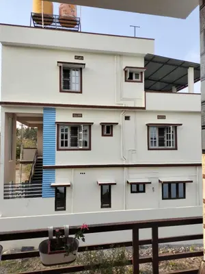 a white building with black windows and a balcony at 
