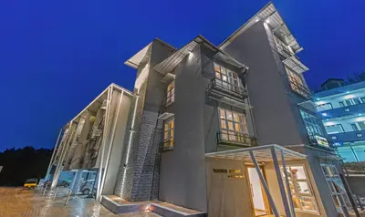a large building with glass doors in front of it at Treebo Windsor Heights, 8 Mins To Ketti Valley View Point in Ooty