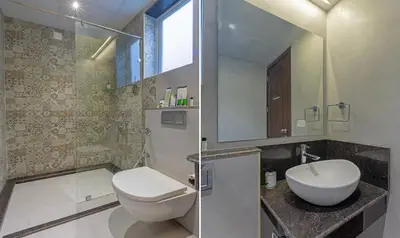 a bathroom with a toilet and a sink and a mirror at Treebo Windsor Heights, 8 Mins To Ketti Valley View Point in Ooty