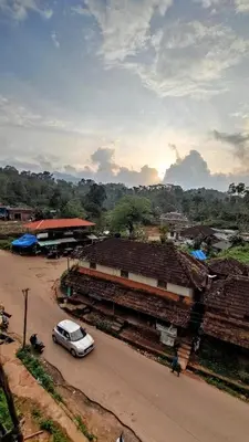 a car parked on a road in a village at Paadi Inn in Kakkabe