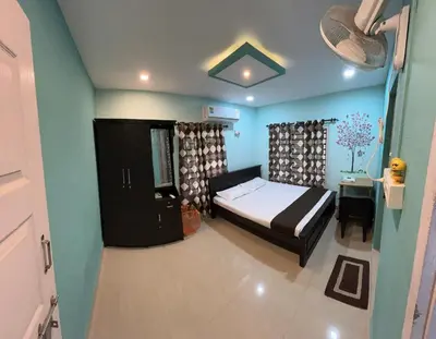 a bedroom with a bed and a desk and a bed sidx sidx sidx at Namasthe Inn AC, Ottapalam-Palakkad Highway, Lakkidi in Ottappālam