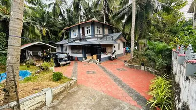 a house with a driveway in front of it at Namasthe Inn AC, Ottapalam-Palakkad Highway, Lakkidi in Ottappālam