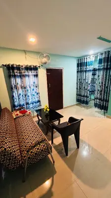 a living room with a leopard print couch and a table at Namasthe Inn AC, Ottapalam-Palakkad Highway, Lakkidi in Ottappālam