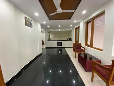 a hallway with a living room with a ceiling at Daffodils Luxury Airport Suites in Angamali