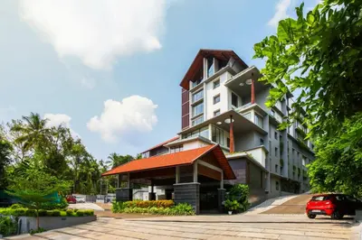 a building with a red roof at Woodbine Foliage in Malappuram