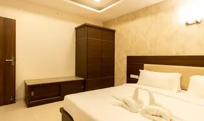 a bedroom with a bed with white towels on it at The Bee Hives , Nectar Nest in Coimbatore