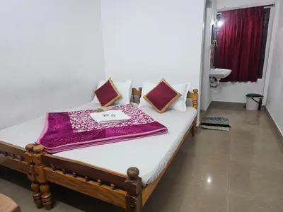 a bed in a room with a purple blanket on it at Cicily Cottage in Munnar