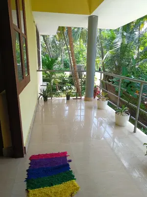 a lobby with a colorful rug on the floor at Pebbles in Kozhikode
