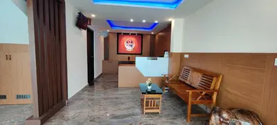 a waiting room with a bench and a table at Sanjose Residency in Virajpet