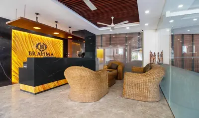 a lobby with wicker chairs and a sign that reads bantam at Treebo Brahma, Wayanad in Sultan Bathery
