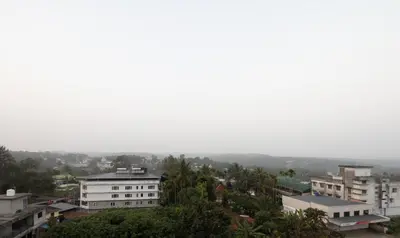 a view of a city with buildings and trees at Treebo Brahma, Wayanad in Sultan Bathery