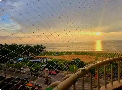 a view of a beach at sunset from a fence at Ivory sea castle in Kozhikode