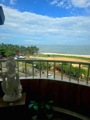 a view of the beach from the balcony of a resort at Ivory sea castle in Kozhikode