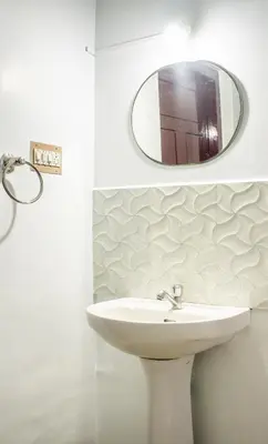 a bathroom with a sink and a mirror at Padmanabhan's Homestay in Thrissur, Punkunnam in Trichūr