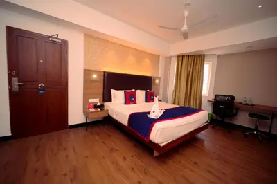 a hotel room with a bed and a desk at Zip by Spree Hotels Mangala International in Coimbatore