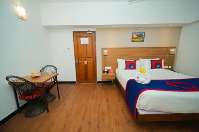 a hotel room with a bed and a table at Zip by Spree Hotels Mangala International in Coimbatore
