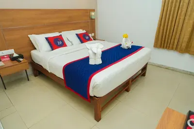 a bed with two stuffed animals sitting on top of it at Zip by Spree Hotels Mangala International in Coimbatore