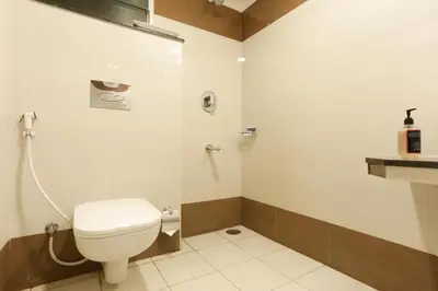 a bathroom with a toilet and a shower at Zip by Spree Hotels Mangala International in Coimbatore
