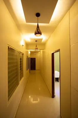 a corridor in a house with a ceiling at The Green Room Residency in Padinjarathara