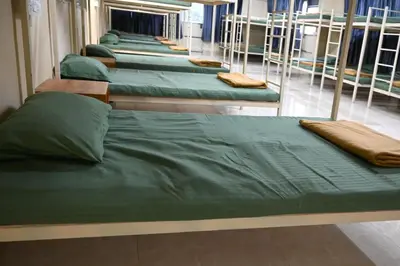 a row of green bunk beds in a room at The Green Room Residency in Padinjarathara