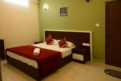 a bedroom with a bed with red and green walls at The Green Room Residency in Padinjarathara