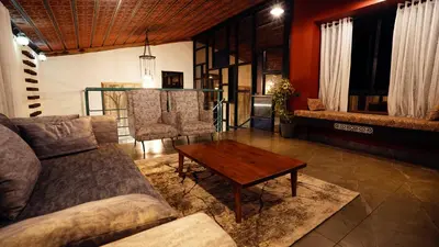 a living room with a couch and a coffee table at Lofterra in Kozhikode