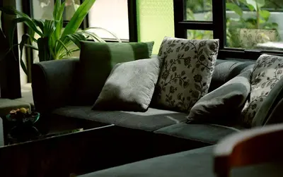 a couch with pillows on it in a living room at Lofterra in Kozhikode