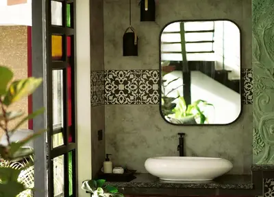 a bathroom with a sink and a mirror at Lofterra in Kozhikode