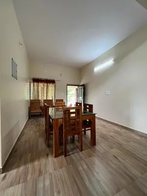a dining room with a table and chairs at Marina Homestay in Devāla