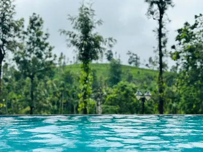 a pool of water with trees in the background at Marina Homestay in Devāla