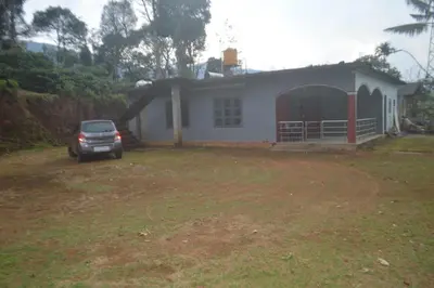 a car parked in front of a house at Kalpavruksha Farmstay by StayApart in Madikeri
