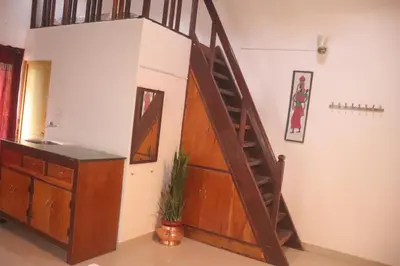 a spiral staircase in a room with a desk at Coorg Northbreeze Estate stay in Madikeri