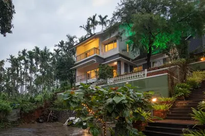 a house with stairs leading up to it at Dazzle Villa Resort in Kalpetta