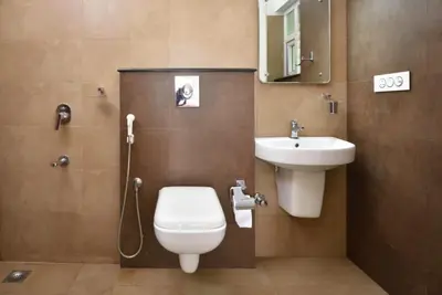 a bathroom with a toilet and a sink at Dazzle Villa Resort in Kalpetta